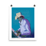 A man wearing a cowboy hat intently plays on his keyboard. Laura Hunt, artist